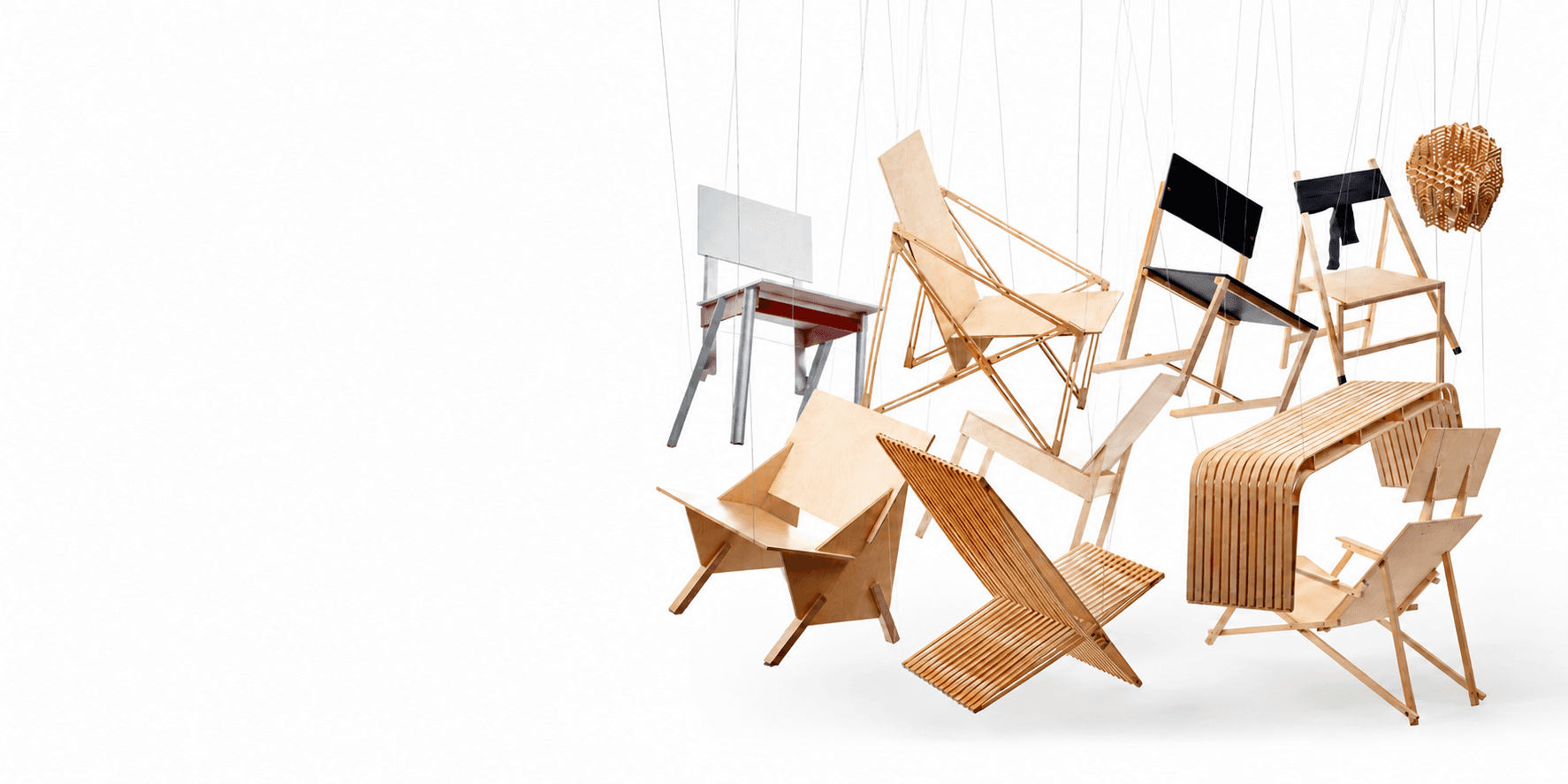 An array of TORII chairs suspended in mid-air against white
